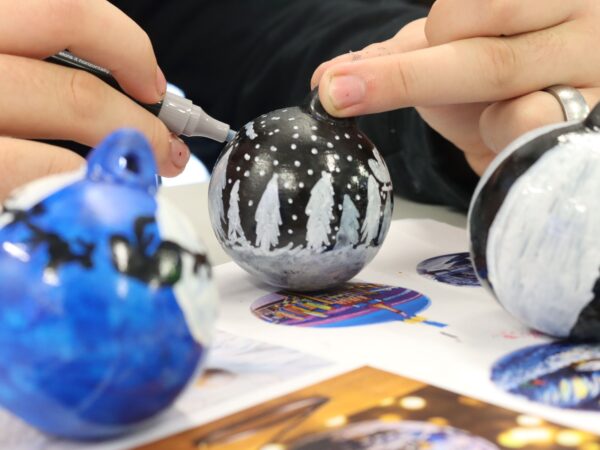 Student painting a bauble