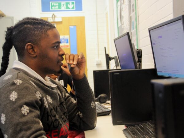 student looking at a computer in a classroom