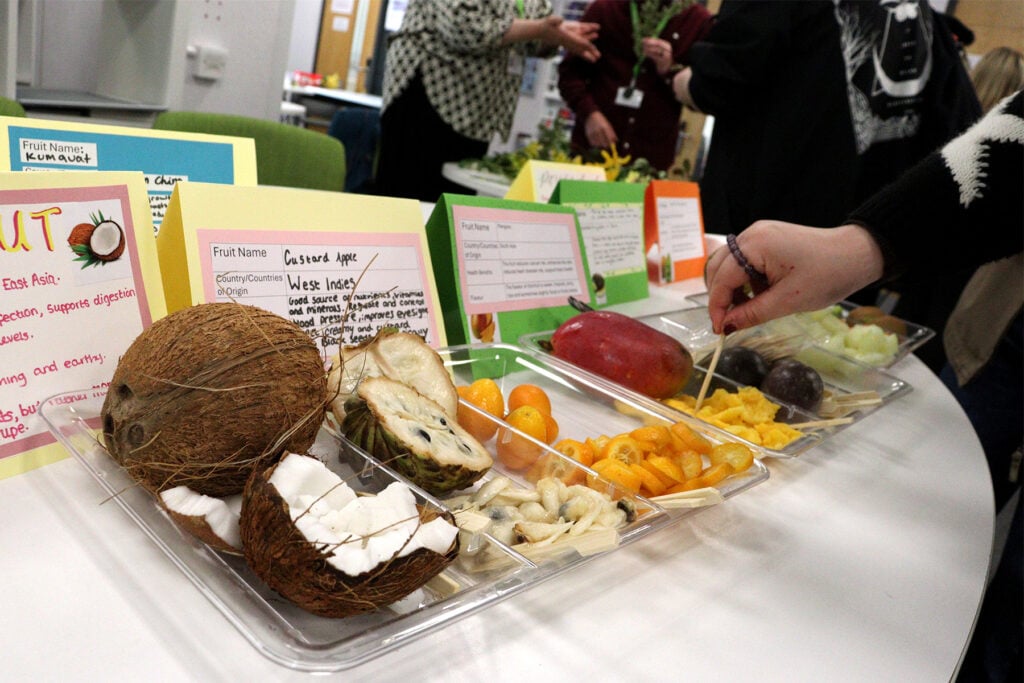 a collection of fruit, including a coconut