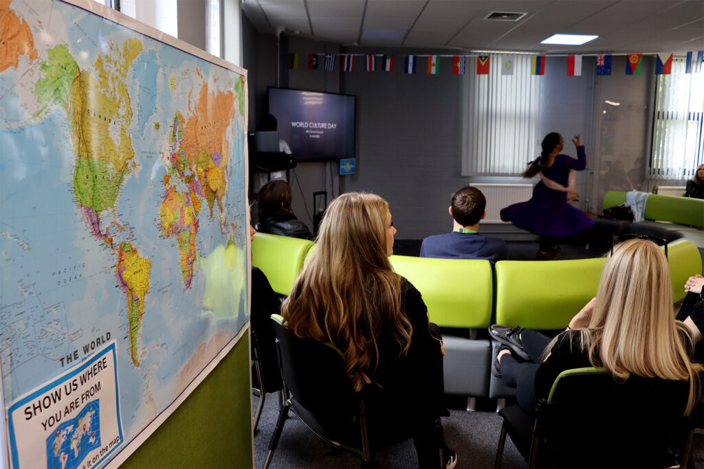student in a classroom with a map