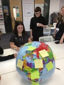 A globe with post-it notes stuck to it