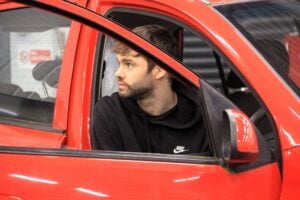 automotive student in red car