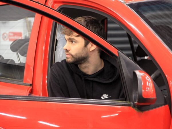 automotive student in red car
