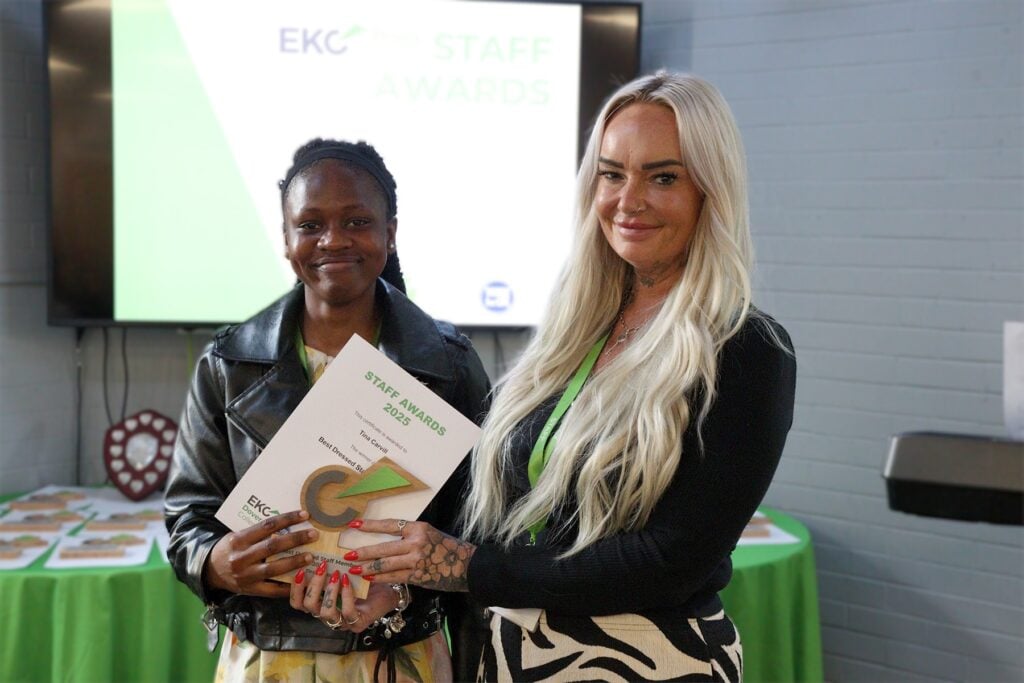 Student presenting award to staff member