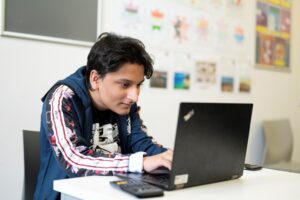 male student looking at laptop