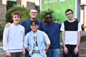 group of T Level Digital students at Results Day 2025. They are standing and smiling in front of the College sign.
