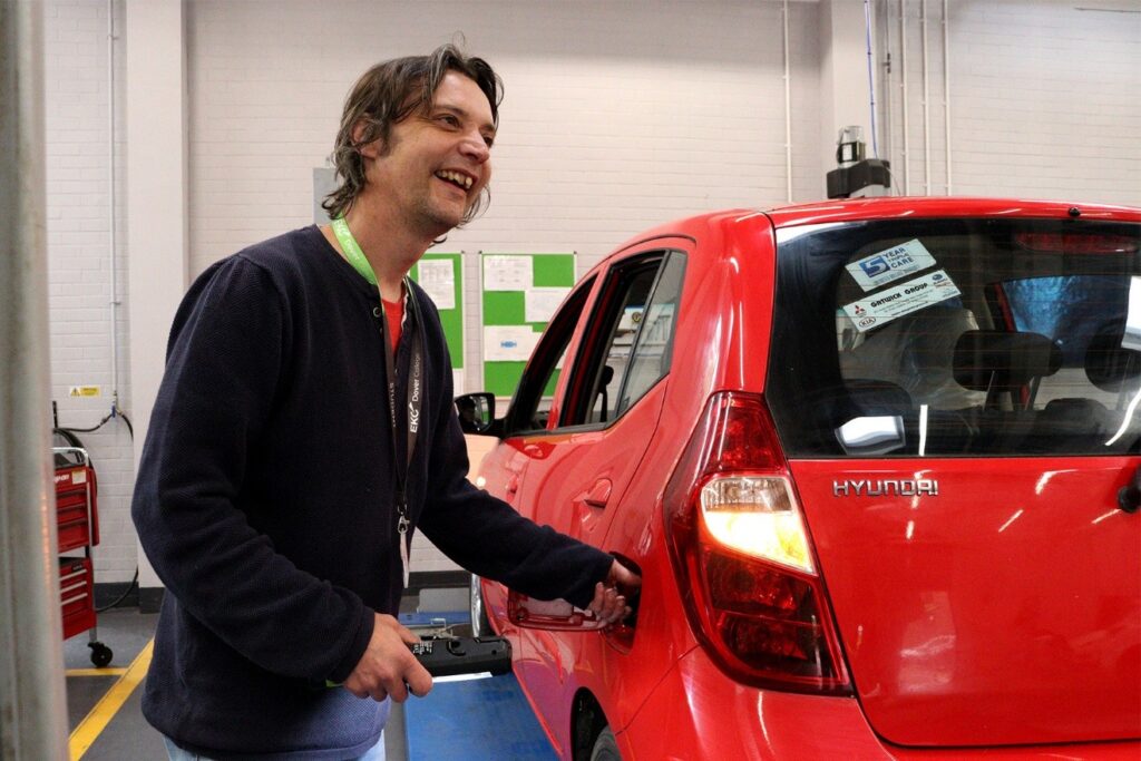 Ben laughing whilst turning petrol cap
