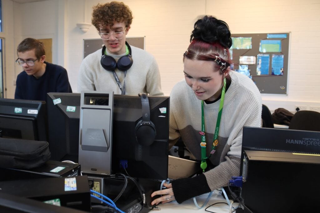 computing students work with a switch for a networking workshop
