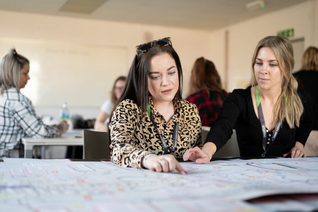 Students sat at a table looking at work