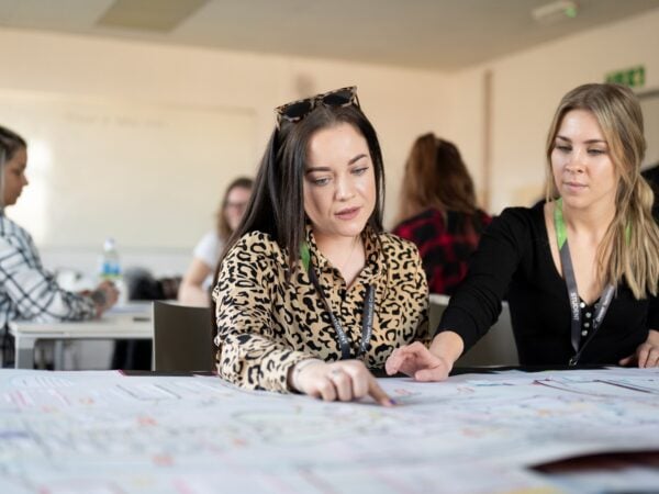 Students sat at a table looking at work