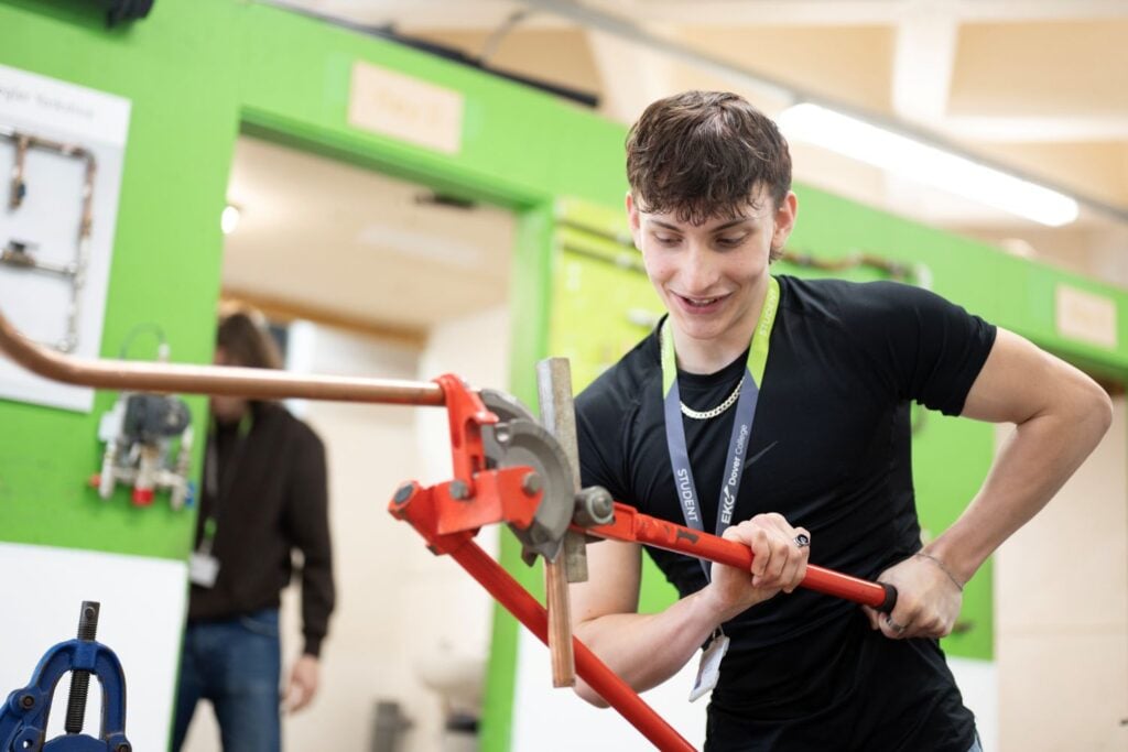plumbing student bends pipe at EKC Dover College