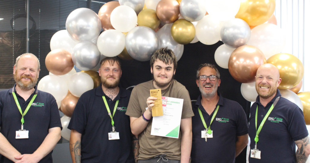 Jacob having a photo with his tutors and winning the Inspirational Learner award.