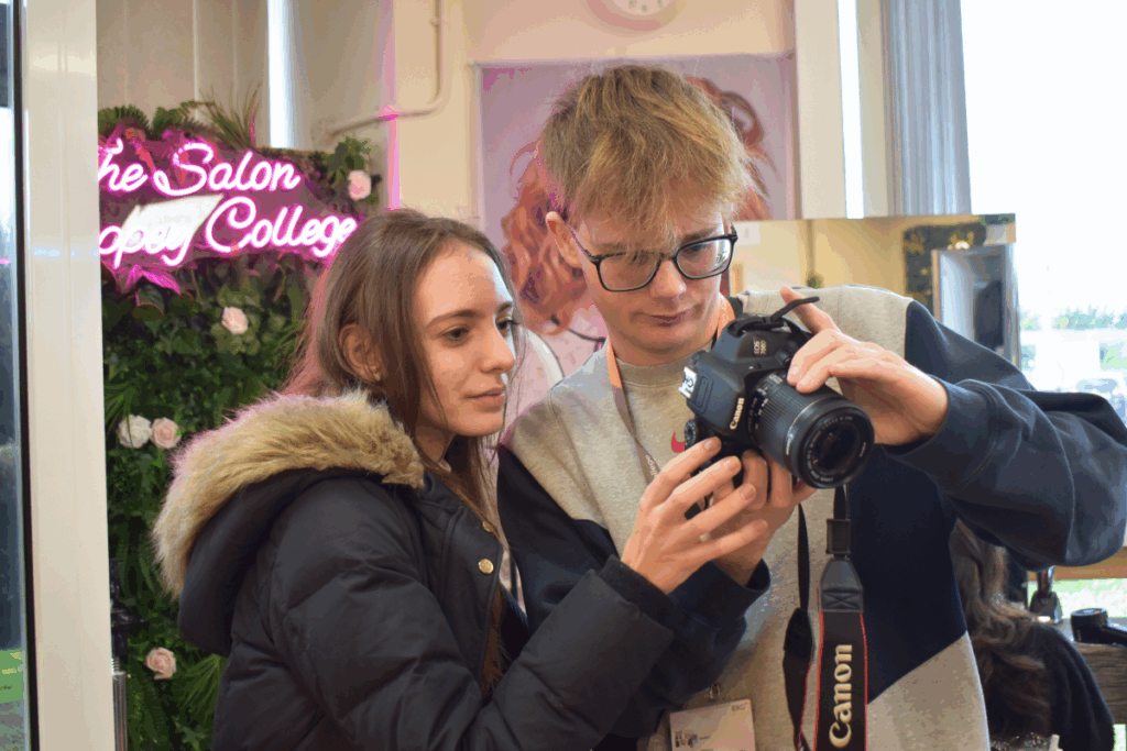 two students look at a digital camera