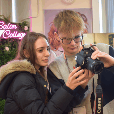 two students look at a digital camera