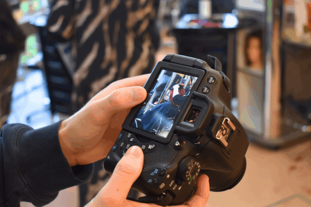 a student looking at the display screen on a camera