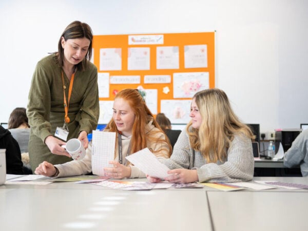 two female students in a business course with female teacher