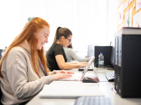 a female student looks at a computer