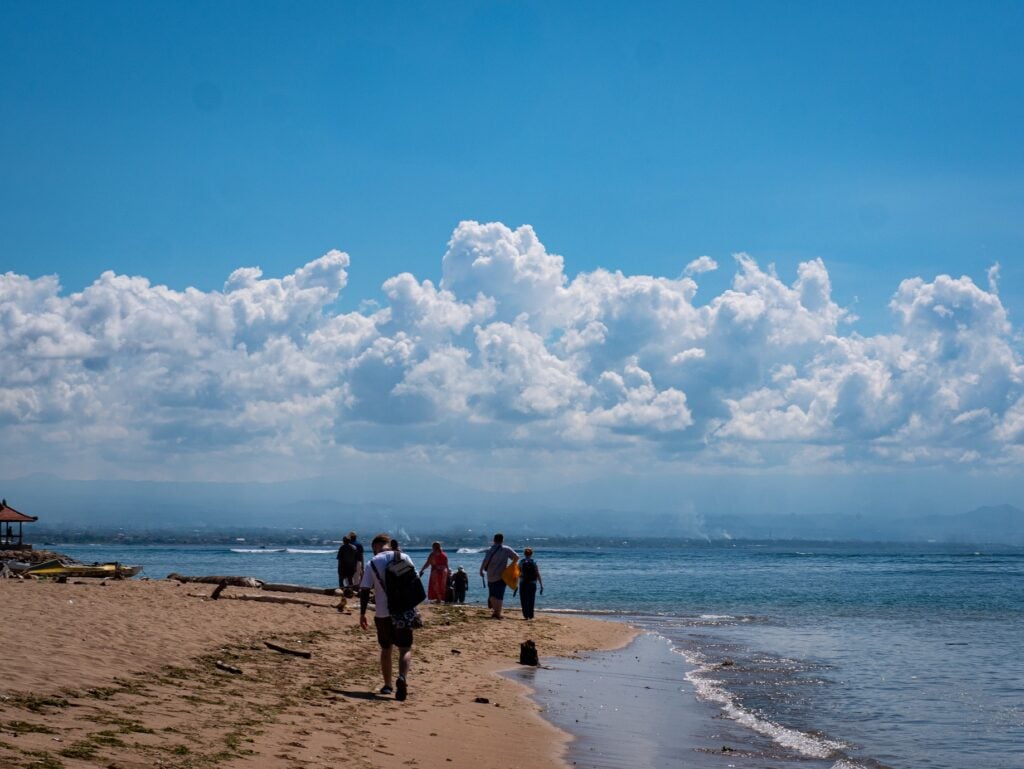 Students walking along the beach