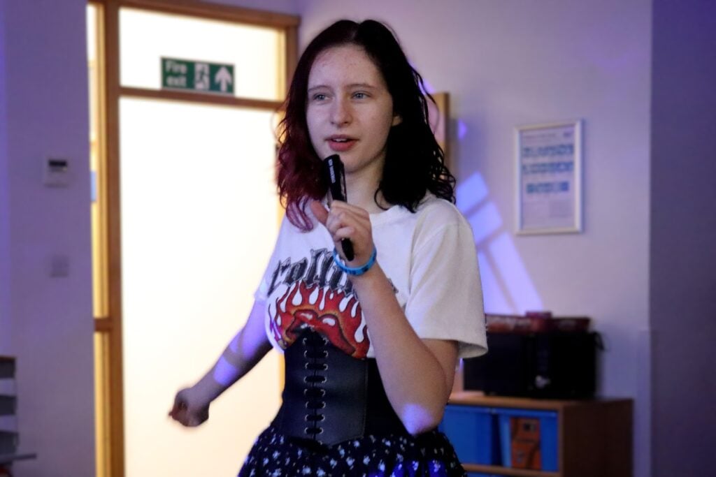 Young woman dancing in dark room