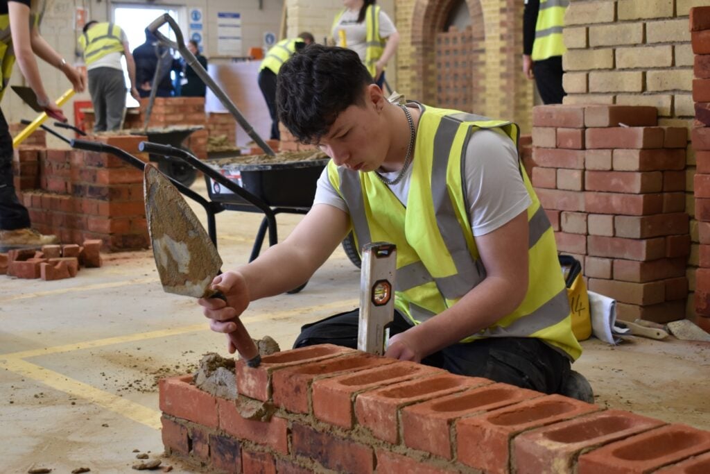a construction student works in the college workshop