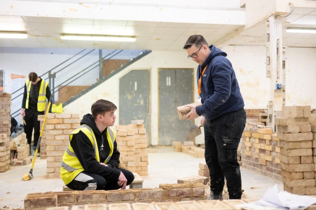 Programme Director speaks with a construction student