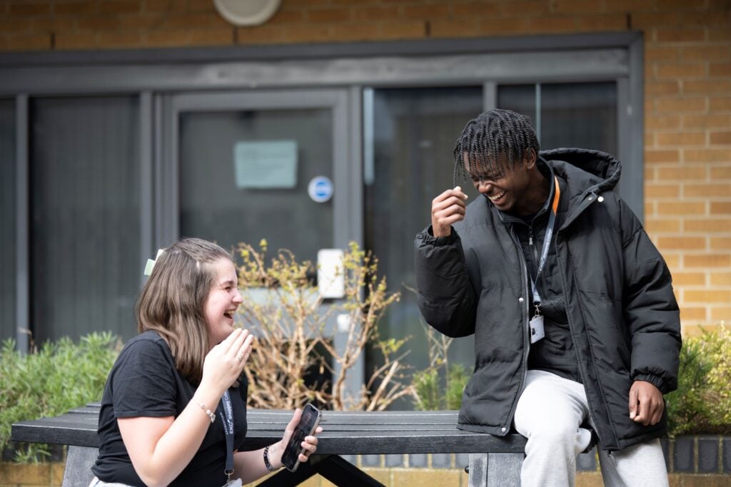 two college students laughing together