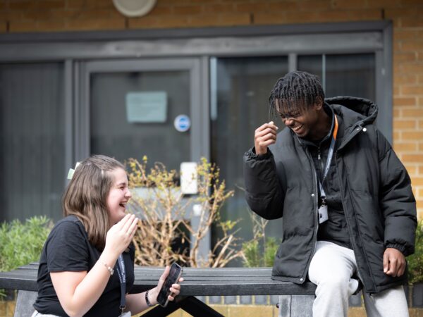 two college students laughing together
