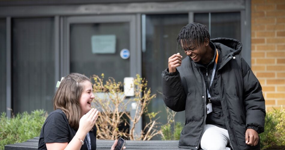 two college students laughing together