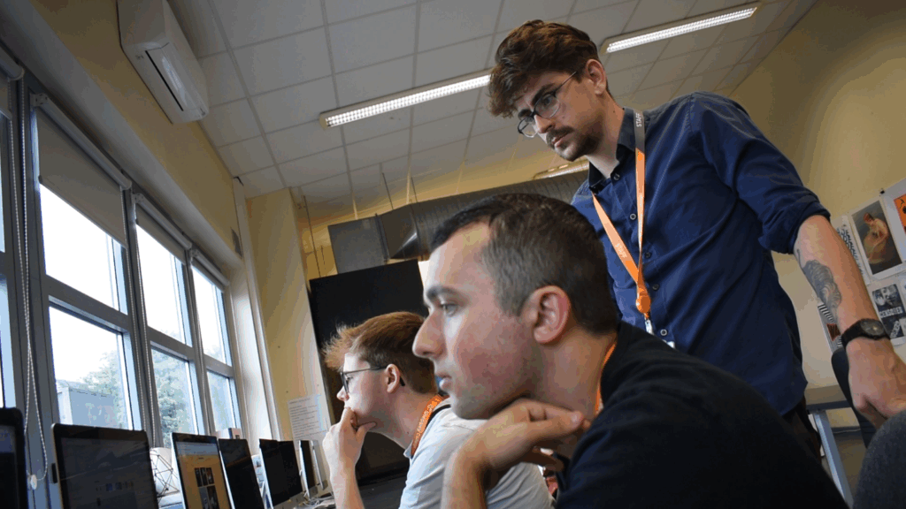 creative media student learns in the classroom with lecturer