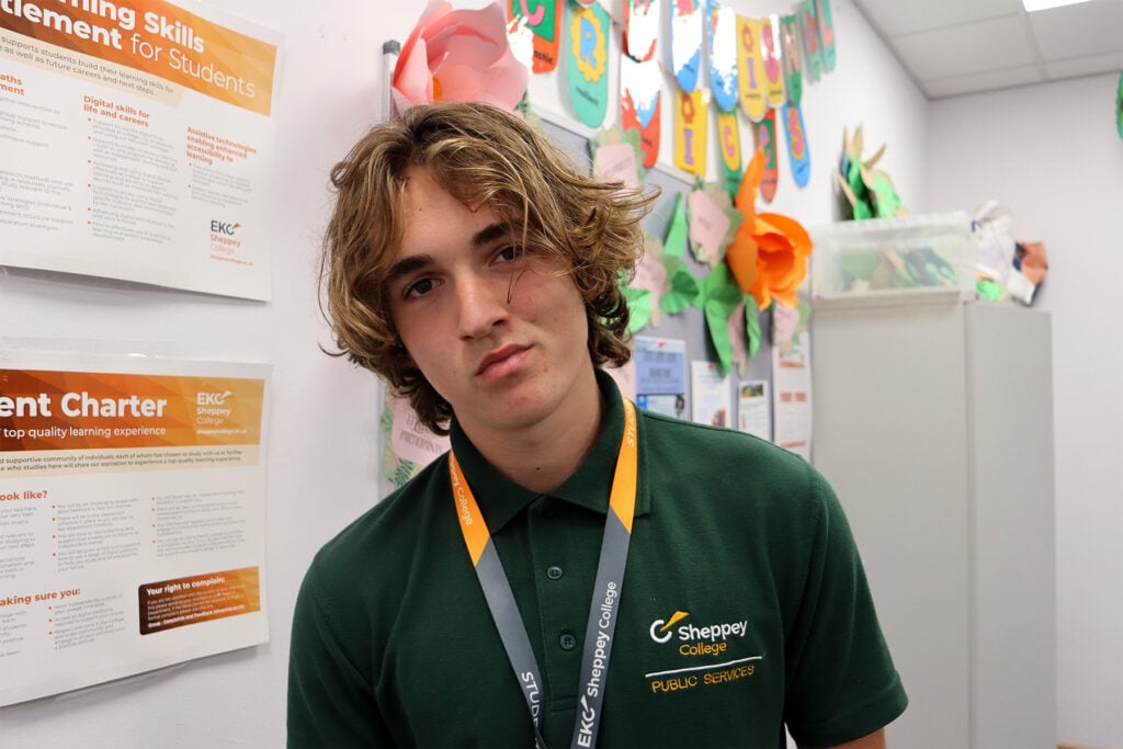 Headshot of young man standing in a classroom