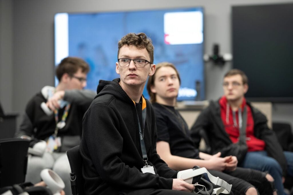 student listening to lecturer in classroom