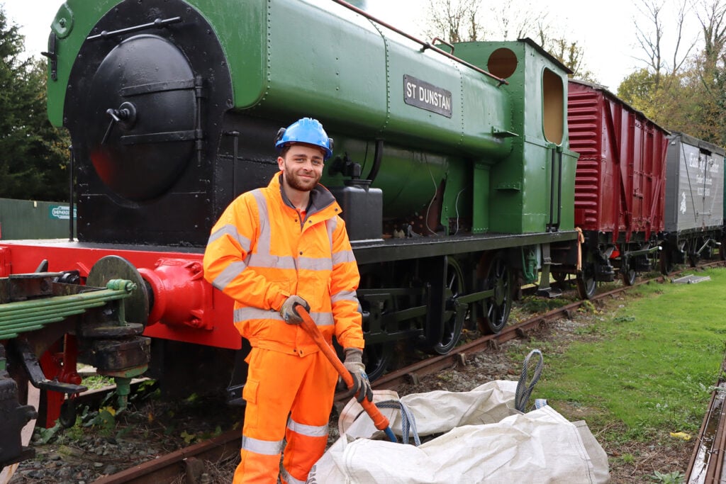 Rail worker stood in front of a train