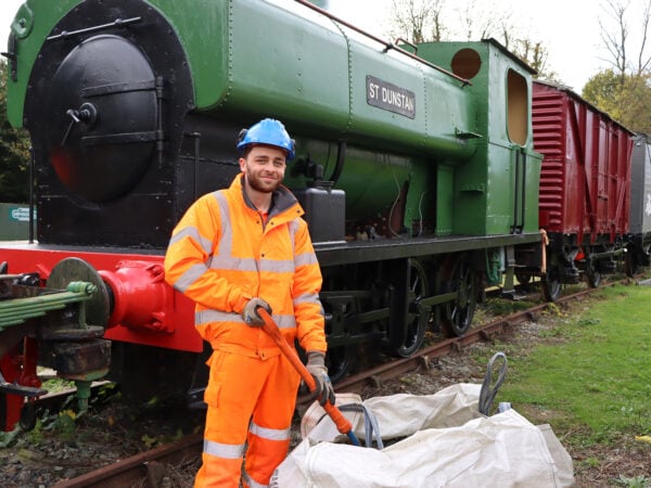 Rail worker stood in front of a train
