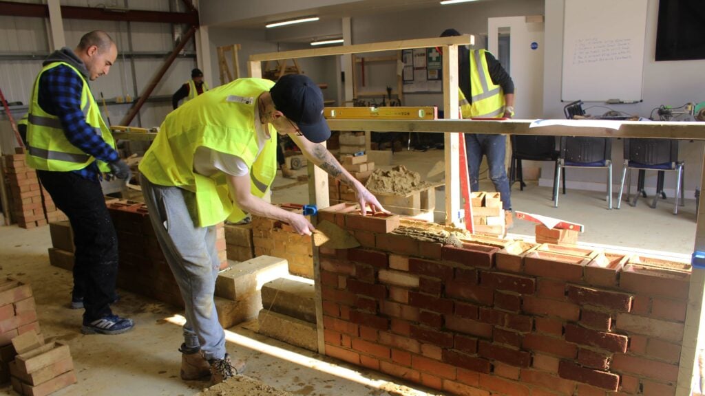 Bricklaying student working on an end piece assessment