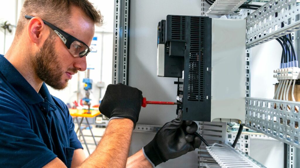 man with safety googles on carrying out electrical work