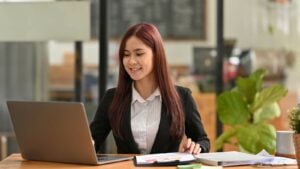 a student looking at a laptop to update her cv