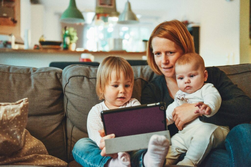 A person and two children sitting on a couch