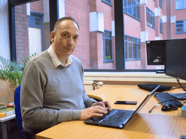 profile photo of recruitment officer sitting at a computer