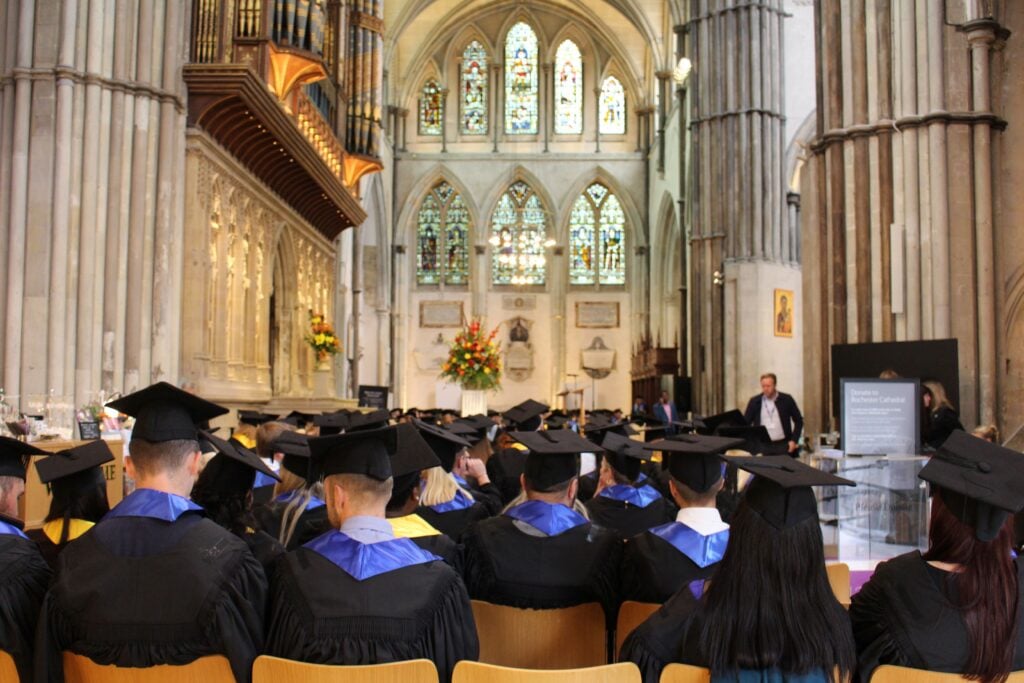 Students sat in graduation gowns