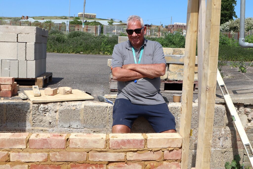 Mark smiling at the camera, outside the centre