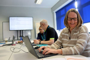 Students working on a laptop in a classroom