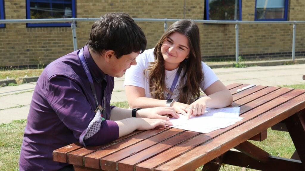 students talking on a bench