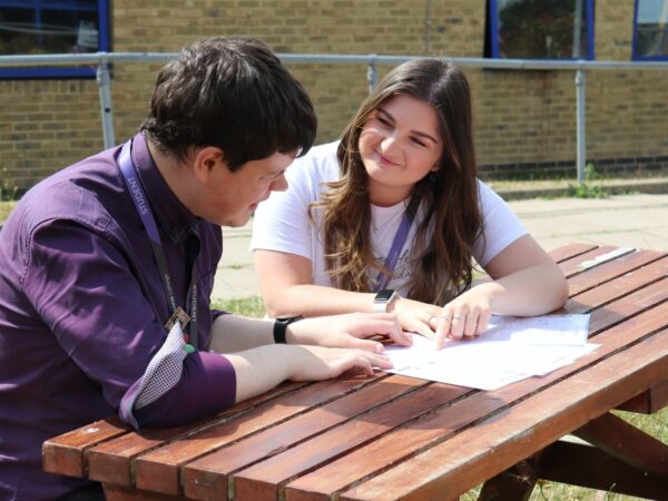 students talking on a bench