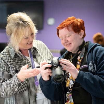 Student and teacher looking at camera