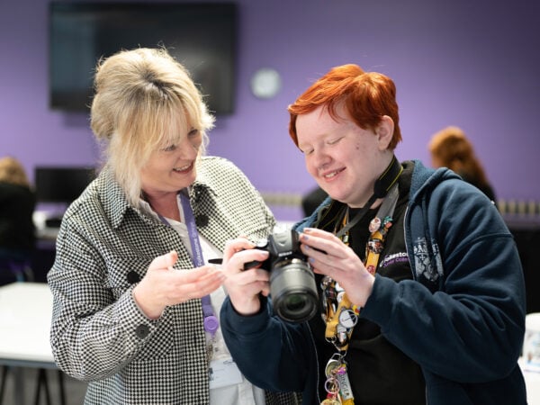 Student and teacher looking at camera