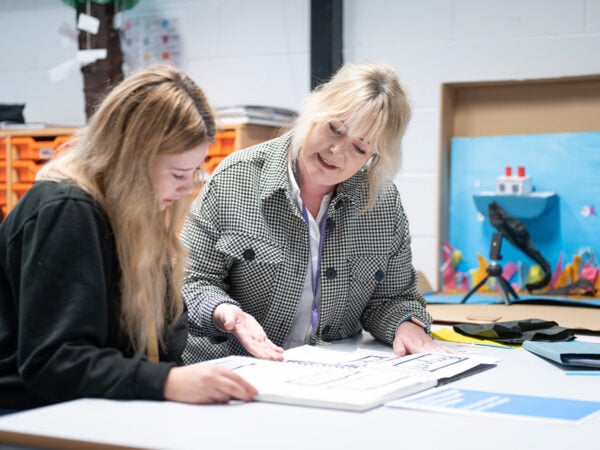 Staff talking to student in the Junior College art studio