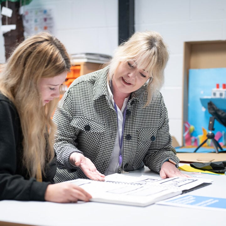 Staff talking to student in the Junior College art studio