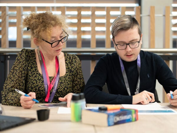 Staff helping student in the LRC