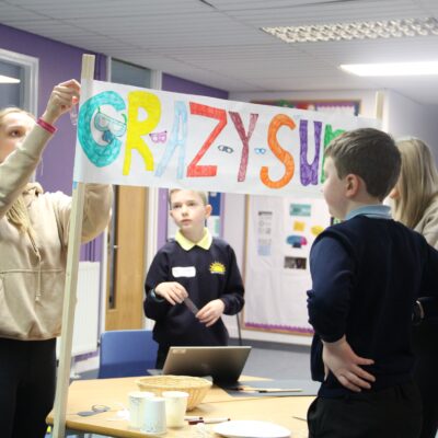 Students working with school children to create their own marketstall