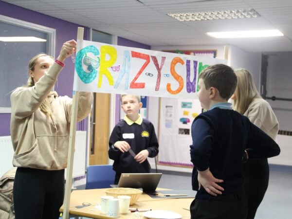 Students working with school children to create their own marketstall